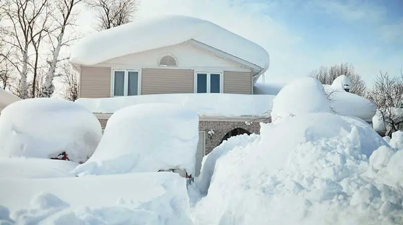 A tidy, snow-covered front yard requiring no landscaping
