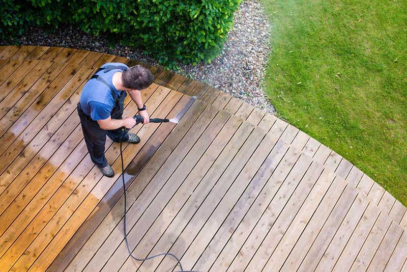 Power washing a driveway and walkway to refresh a home's exterior