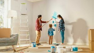 a family is painting their living room after reading about the tip on how to boost your homes curb appeal