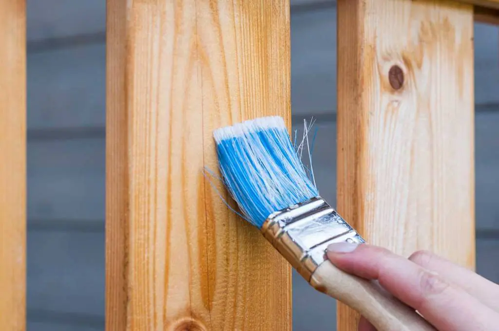Inspecting fencing on a Brantford home in spring